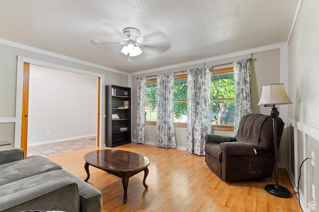 335 S 600 E, Smithfield, UT 84335 - living area with a ceiling fan, a textured ceiling, crown molding, light wood-style flooring, and baseboards
