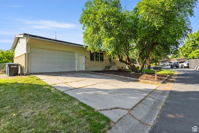 335 S 600 E, Smithfield, UT 84335 - view of front of property featuring a garage, driveway, and a front lawn