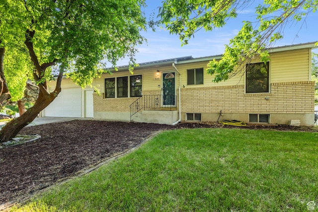 335 S 600 E, Smithfield, UT 84335 - ranch-style home with a front lawn, a garage, driveway, and brick siding
