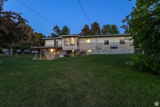 335 S 600 E, Smithfield, UT 84335 - back of house with a lawn and brick siding