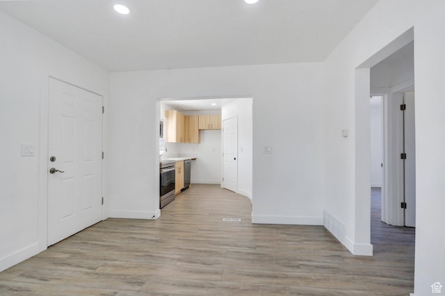 520 S Jeremy St W, Salt Lake City, UT 84104 - kitchen with appliances with stainless steel finishes, light wood-style flooring, light countertops, baseboards, and light brown cabinets