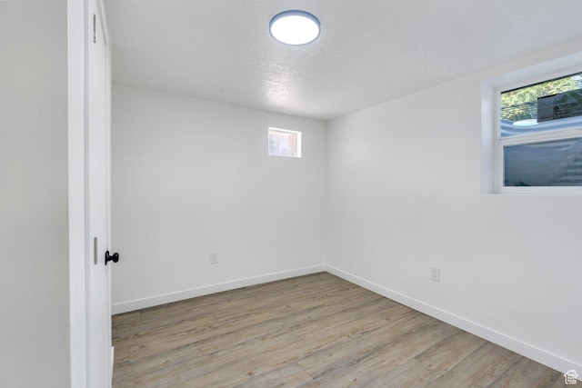 520 S Jeremy St W, Salt Lake City, UT 84104 - unfurnished room featuring plenty of natural light, wood finished floors, baseboards, and a textured ceiling