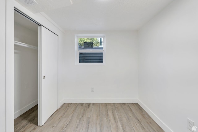 520 S Jeremy St W, Salt Lake City, UT 84104 - unfurnished bedroom with light wood-style floors, a closet, and baseboards