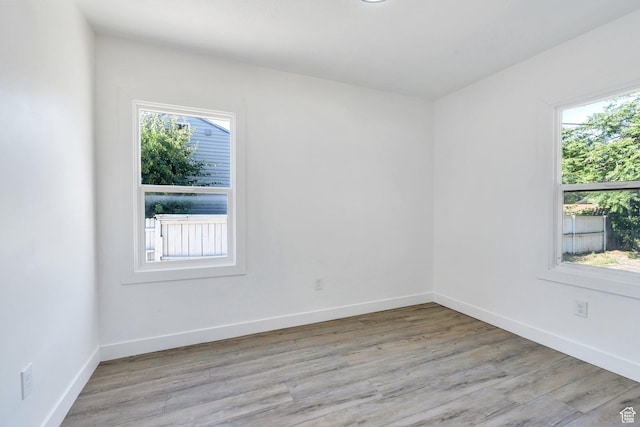 520 S Jeremy St W, Salt Lake City, UT 84104 - empty room with plenty of natural light, light wood finished floors, and baseboards