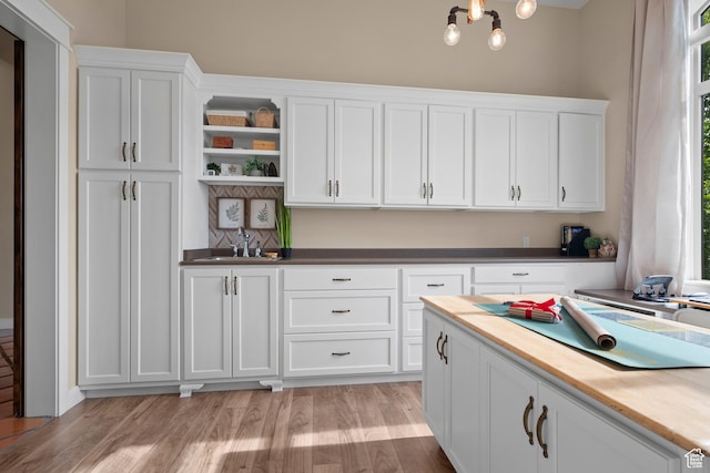 1827 S Hillcrest Cir, Mapleton, UT 84664 - kitchen with open shelves, a sink, white cabinets, and light wood finished floors