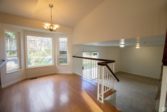 6033 S 4520th St W, Salt Lake City, UT 84118 - staircase with a chandelier, healthy amount of natural light, wood finished floors, and high vaulted ceiling