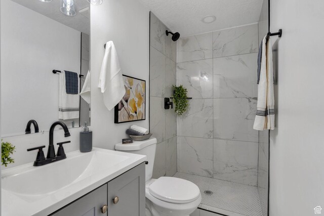 195 E 200 S, Nephi, UT 84648 - bathroom featuring vanity, a marble finish shower, toilet, and a textured ceiling