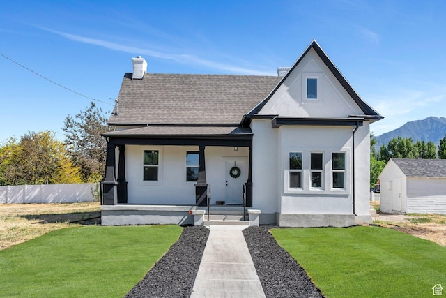 195 E 200 S, Nephi, UT 84648 - view of front facade featuring covered porch, a chimney, a mountain view, roof with shingles, and stucco siding