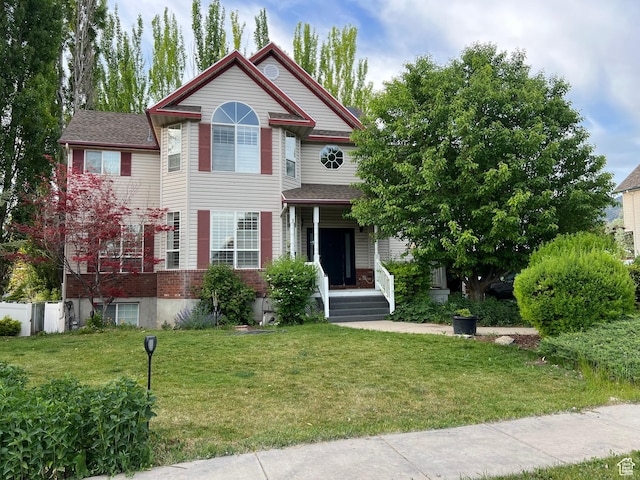 1107 E 1625 N, North Logan, UT 84341 - victorian house featuring a front yard and a porch