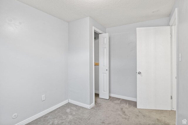 1522 W 1200 N, Layton, UT 84041 - unfurnished bedroom with carpet flooring, baseboards, and a textured ceiling