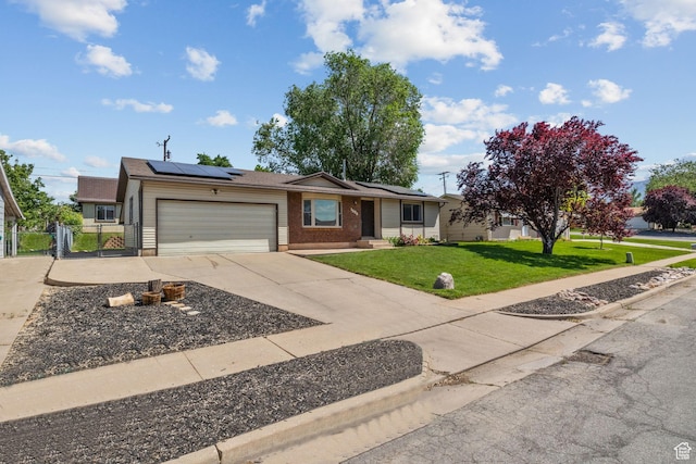 1522 W 1200 N, Layton, UT 84041 - ranch-style home with a garage, concrete driveway, roof mounted solar panels, and brick siding