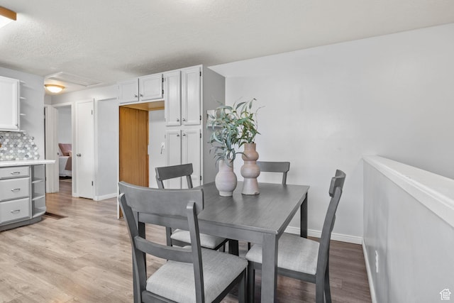 1522 W 1200 N, Layton, UT 84041 - dining space featuring light wood-style floors, baseboards, and a textured ceiling
