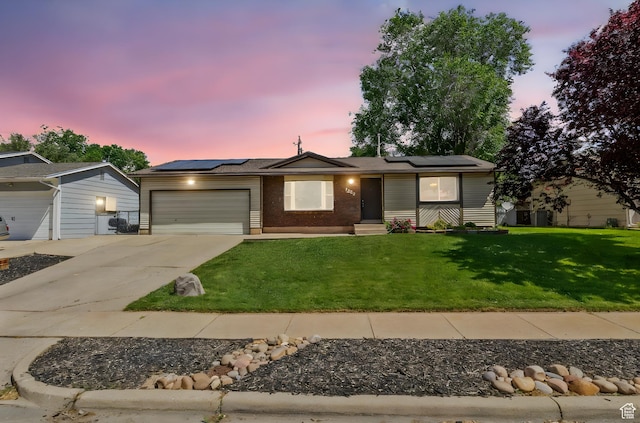 1522 W 1200 N, Layton, UT 84041 - ranch-style house featuring a garage, concrete driveway, a front lawn, solar panels, and brick siding