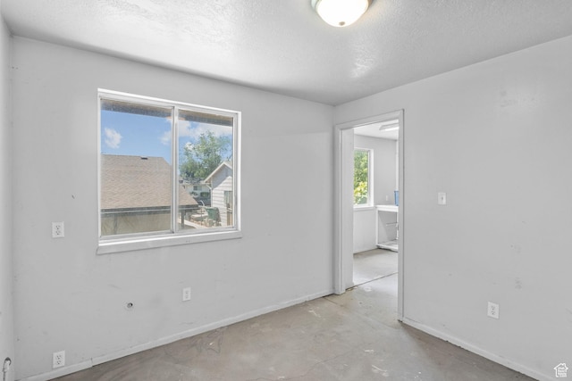 1522 W 1200 N, Layton, UT 84041 - empty room with baseboards, a textured ceiling, and concrete floors