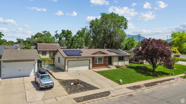 1522 W 1200 N, Layton, UT 84041 - ranch-style house with driveway, roof mounted solar panels, brick siding, and an attached garage