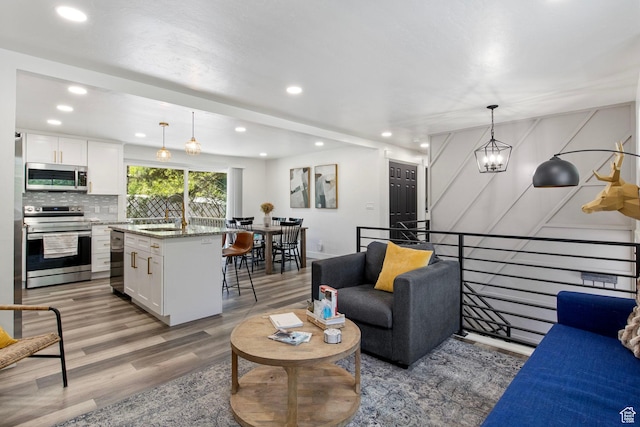 8485 S 1575 E, Sandy, UT 84093 - living area with light wood-style flooring and recessed lighting