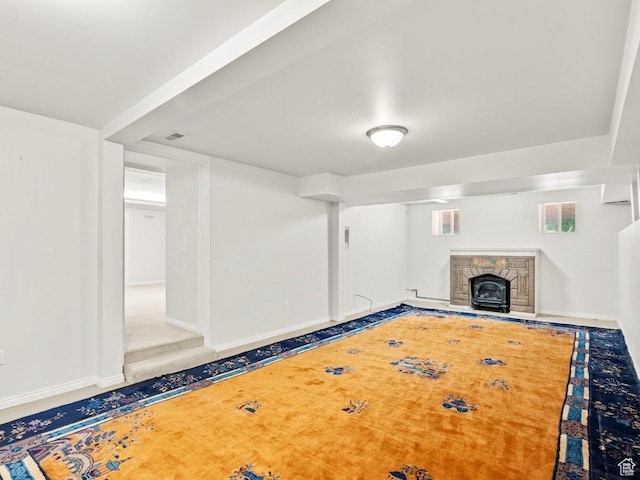 1146 E Harvard Ave S, Salt Lake City, UT 84105 - unfurnished living room featuring a stone fireplace and baseboards