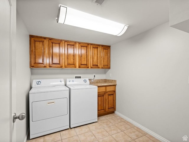 1146 E Harvard Ave S, Salt Lake City, UT 84105 - washroom featuring cabinet space, washing machine and clothes dryer, light tile patterned flooring, and baseboards