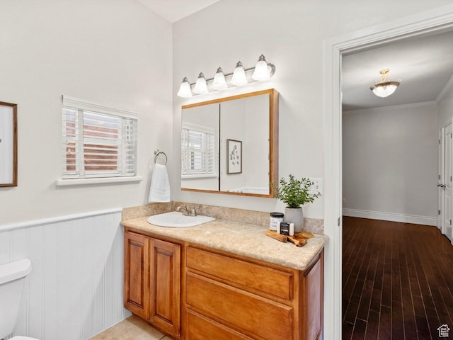 1146 E Harvard Ave S, Salt Lake City, UT 84105 - bathroom with toilet, vanity, a wainscoted wall, and wood finished floors