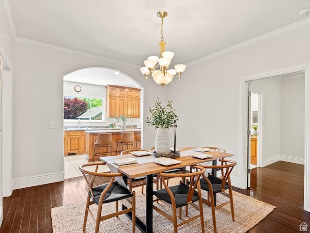 1146 E Harvard Ave S, Salt Lake City, UT 84105 - dining area with hardwood / wood-style flooring, a chandelier, baseboards, and crown molding