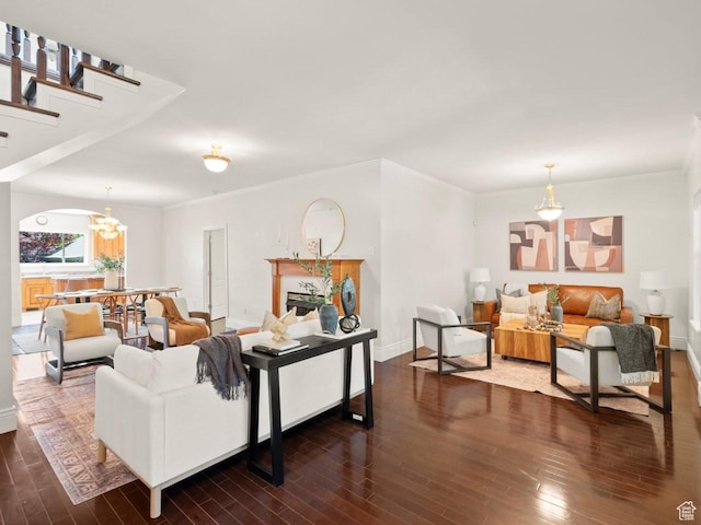 1146 E Harvard Ave S, Salt Lake City, UT 84105 - living room featuring dark wood-style floors, ornamental molding, baseboards, and a chandelier