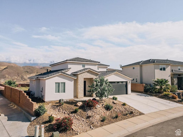583 N Staci Dr, Hurricane, UT 84737 - view of front of home with driveway, an attached garage, and stucco siding