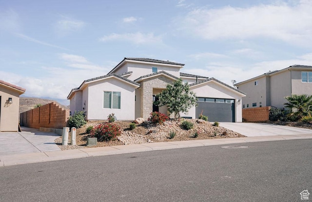583 N Staci Dr, Hurricane, UT 84737 - view of front of property featuring concrete driveway, an attached garage, a tiled roof, and stucco siding