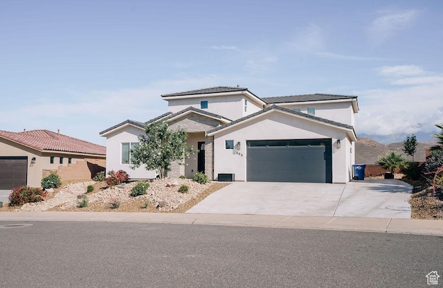 583 N Staci Dr, Hurricane, UT 84737 - traditional home featuring a garage, stucco siding, driveway, and a tile roof