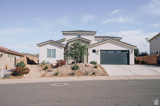583 N Staci Dr, Hurricane, UT 84737 - view of front of house featuring an attached garage, stucco siding, concrete driveway, and a tiled roof