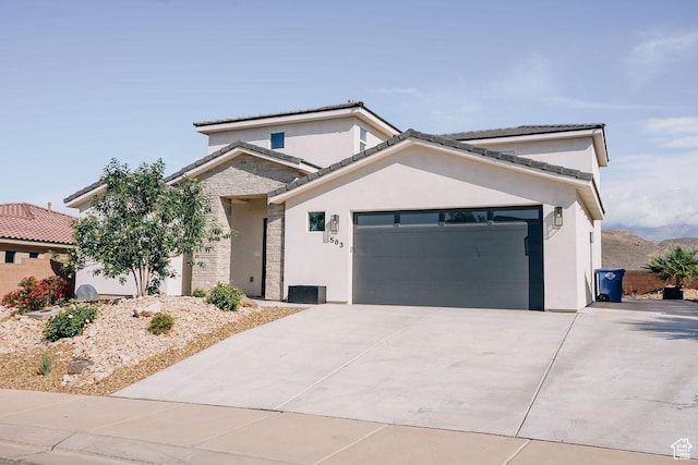 583 N Staci Dr, Hurricane, UT 84737 - view of front facade featuring an attached garage, concrete driveway, stucco siding, and stone siding