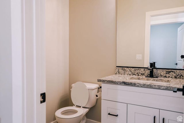 583 N Staci Dr, Hurricane, UT 84737 - bathroom featuring vanity, toilet, and baseboards