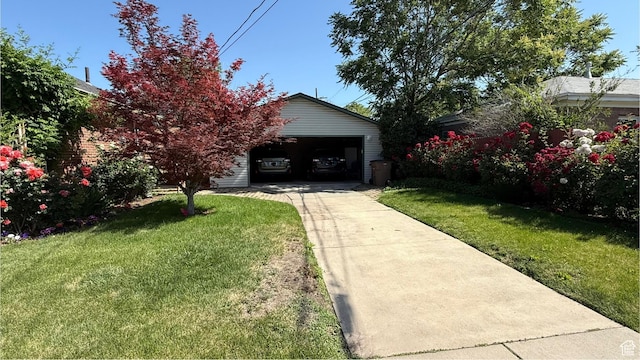 74 W Quayle Ave S, Salt Lake City, UT 84115 - view of grassy yard with driveway, a garage, and an outdoor structure