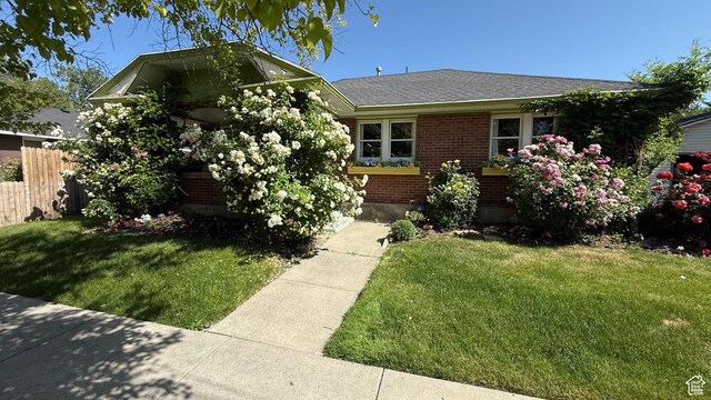 74 W Quayle Ave S, Salt Lake City, UT 84115 - view of front of house featuring brick siding and roof with shingles