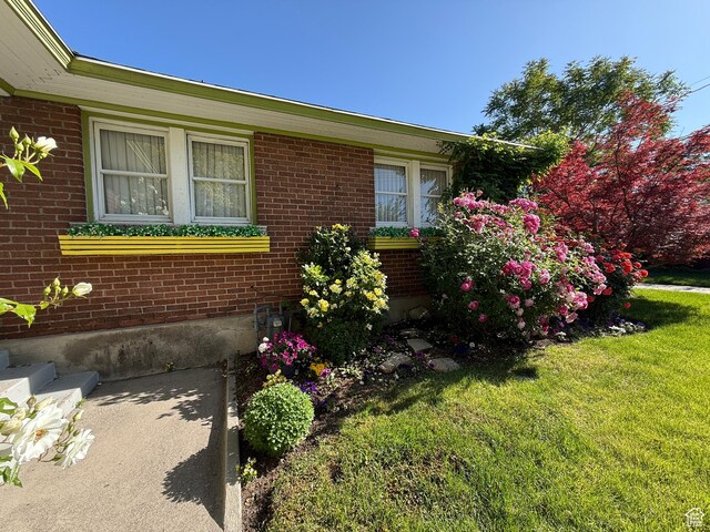 74 W Quayle Ave S, Salt Lake City, UT 84115 - view of property exterior featuring a yard and brick siding