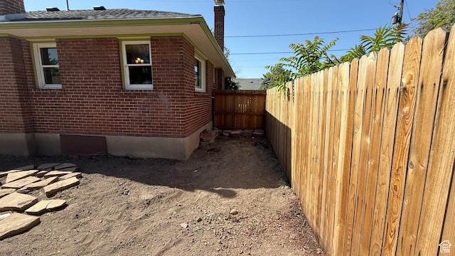 74 W Quayle Ave S, Salt Lake City, UT 84115 - view of side of home featuring brick siding and a chimney
