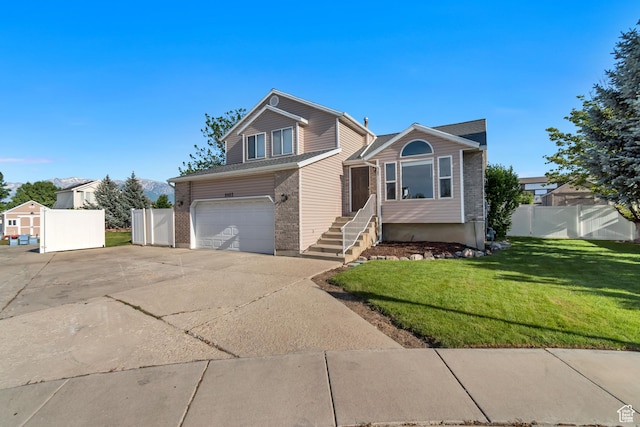 8465 S 1670 W, West Jordan, UT 84088 - view of front of property with driveway, a garage, and brick siding