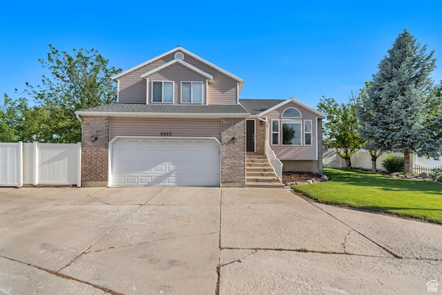 8465 S 1670 W, West Jordan, UT 84088 - traditional-style home with a garage, driveway, and brick siding
