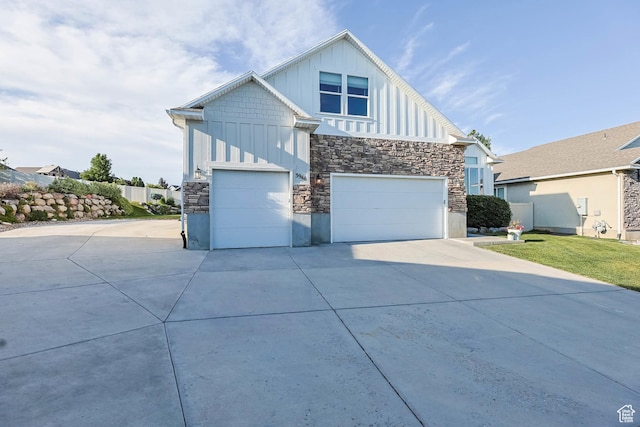 3946 W Birmingham Cir S, Jordan, UT 84009 - contemporary home featuring board and batten siding, stone siding, and concrete driveway