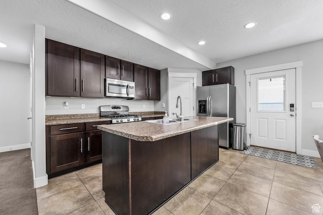 3946 W Birmingham Cir S, Jordan, UT 84009 - kitchen featuring stainless steel appliances, a sink, baseboards, dark brown cabinetry, and recessed lighting