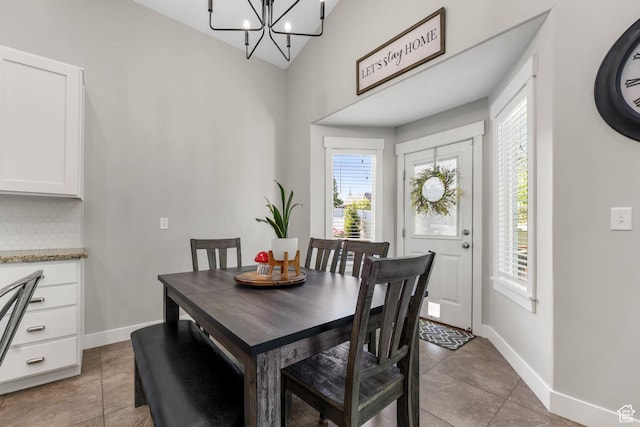3946 W Birmingham Cir S, Jordan, UT 84009 - dining room with baseboards, a chandelier, light tile patterned floors, and high vaulted ceiling