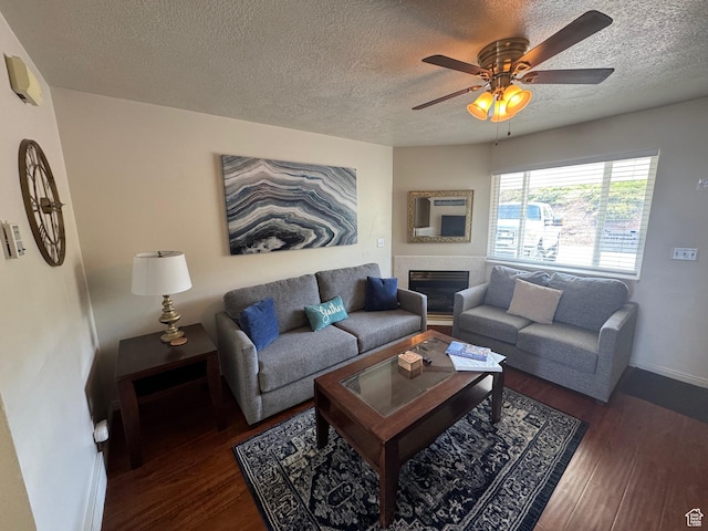 941 N Newberg Pl Unit 2, Garden City, UT 84028 - living room featuring a textured ceiling, wood finished floors, ceiling fan, baseboards, and a fireplace