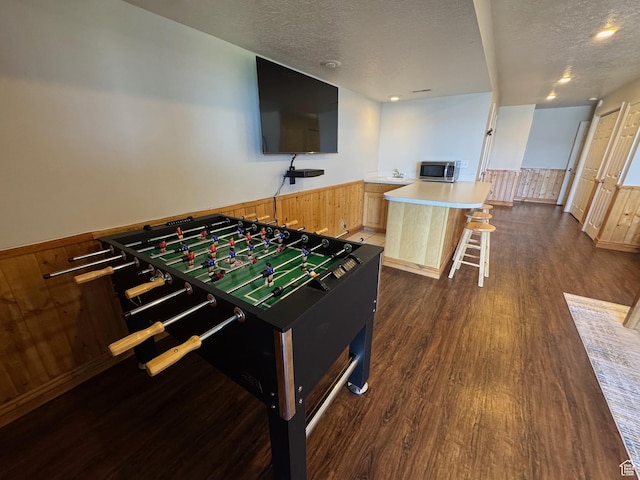 941 N Newberg Pl Unit 2, Garden City, UT 84028 - playroom with a textured ceiling, dark wood finished floors, wainscoting, and recessed lighting