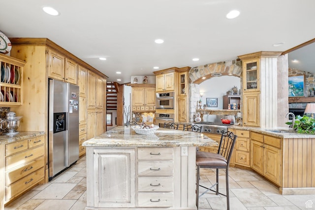 3239 Mountain Top Ln, Park City, UT 84060 - kitchen with stainless steel fridge, a center island, recessed lighting, glass insert cabinets, and a kitchen bar