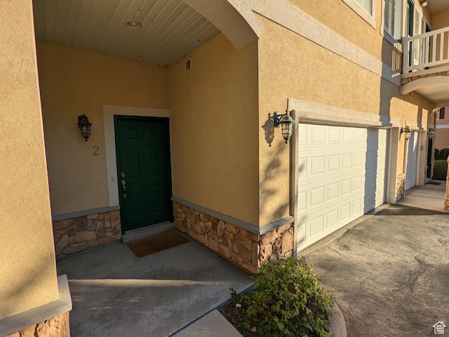 1043 Canyon Meadow Dr Unit 2, Provo, UT 84606 - entrance to property featuring stone siding, stucco siding, an attached garage, and a balcony