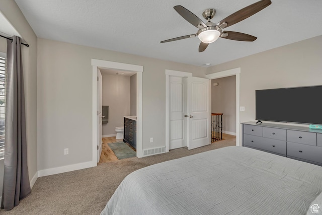 8831 W Digger Ln S, Magna, UT 84044 - bedroom with light colored carpet, baseboards, ensuite bathroom, and a ceiling fan