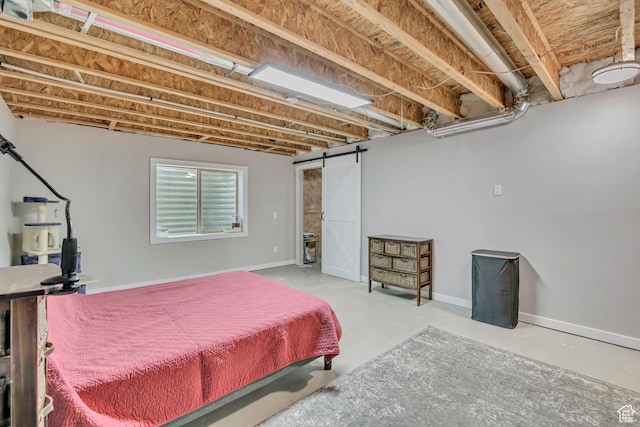 8831 W Digger Ln S, Magna, UT 84044 - bedroom featuring finished concrete flooring, a barn door, and baseboards