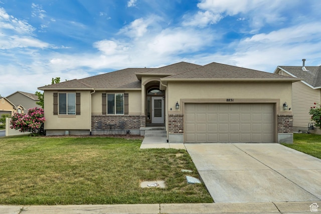 8831 W Digger Ln S, Magna, UT 84044 - view of front of property featuring stucco siding, an attached garage, brick siding, concrete driveway, and a front yard