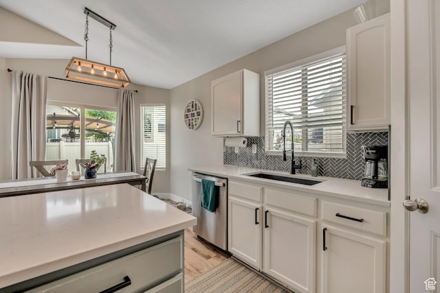 8831 W Digger Ln S, Magna, UT 84044 - kitchen with stainless steel dishwasher, a sink, tasteful backsplash, light countertops, and vaulted ceiling