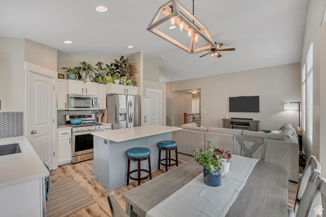 8831 W Digger Ln S, Magna, UT 84044 - dining area with ceiling fan, light wood-type flooring, lofted ceiling, and recessed lighting