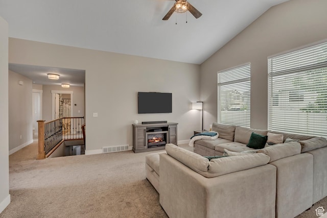 8831 W Digger Ln S, Magna, UT 84044 - living area featuring a ceiling fan, carpet floors, vaulted ceiling, baseboards, and a glass covered fireplace